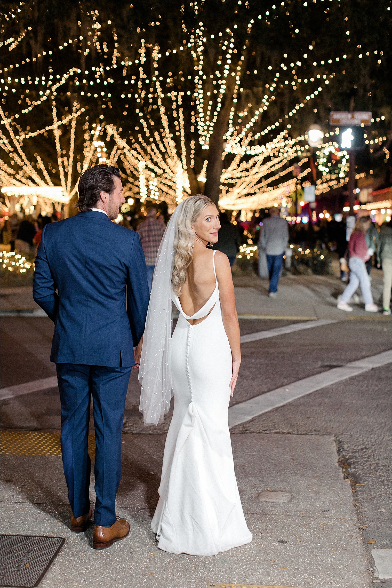 Couple walking during nights of lights, Lightner Museum Wedding St Augustine Florida