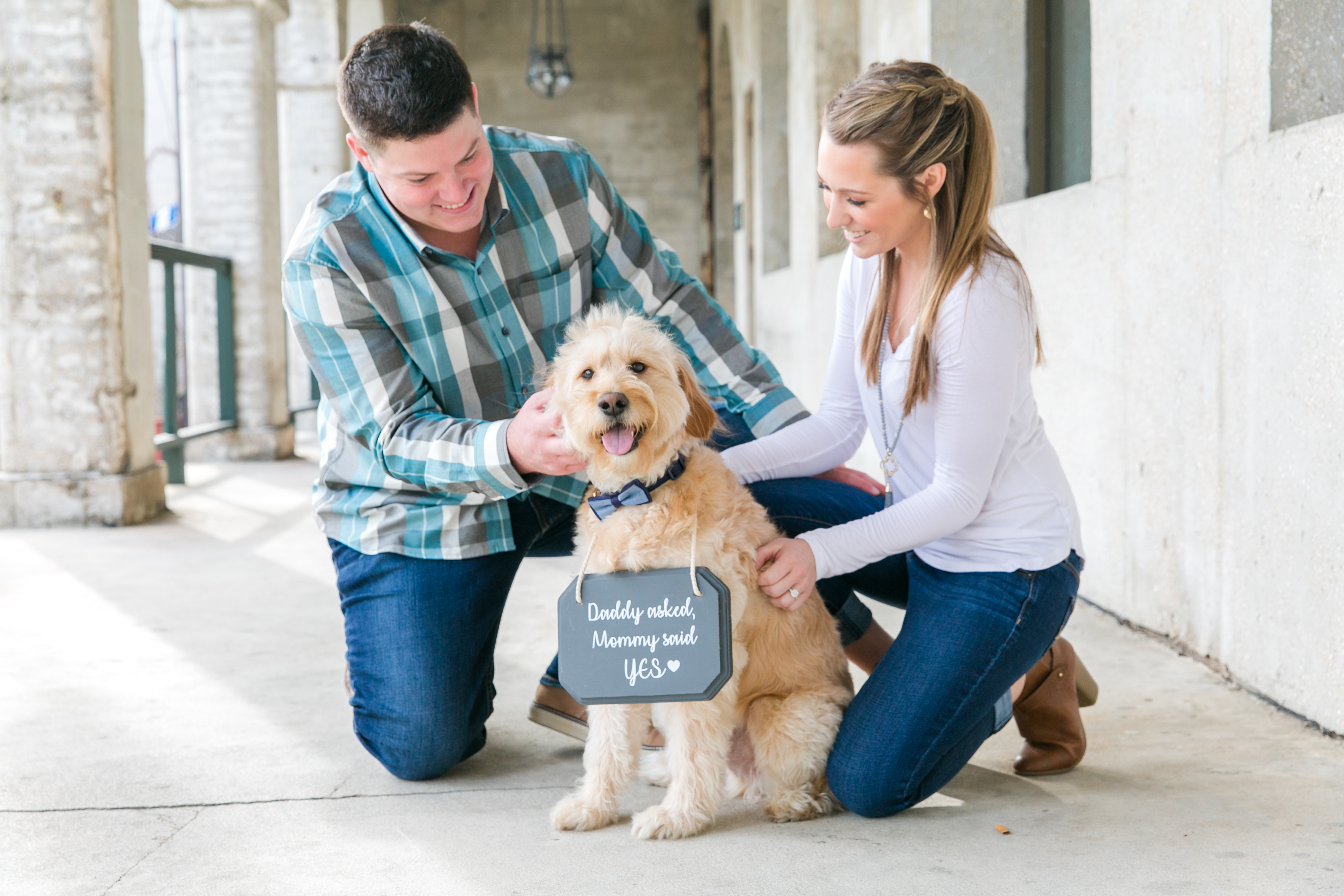 couple sitting with dog during engagement session saint augustine florida
